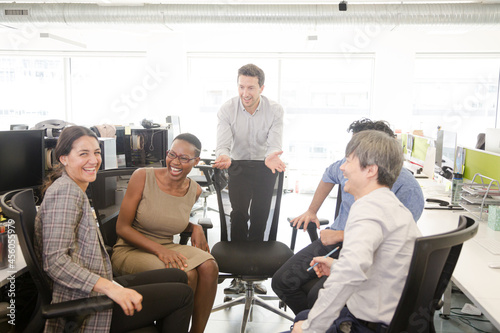 Business people meeting at computer in open plan office