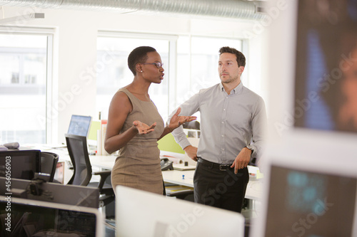 Business people talking in open plan office © KOTO