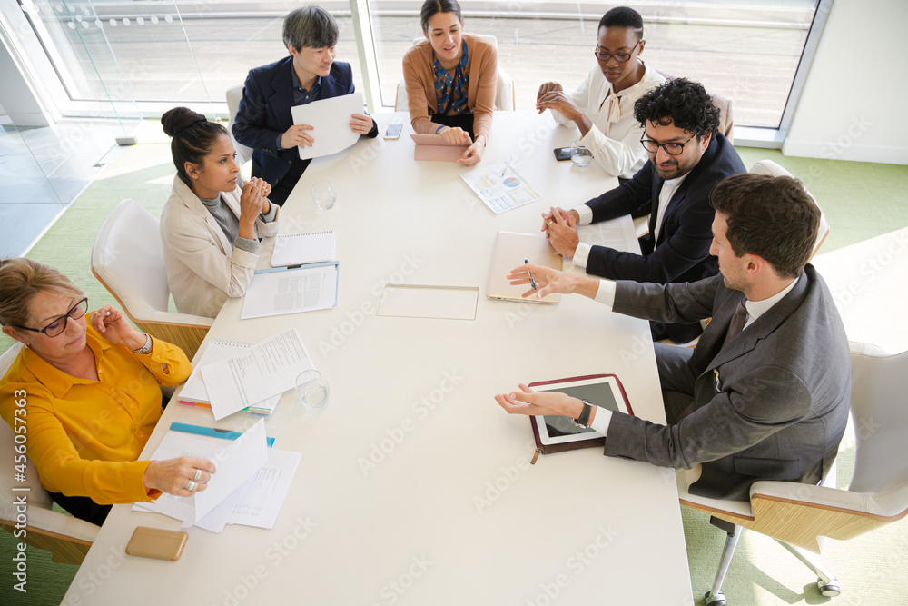 Business people discussing paperwork in conference room Business people discussing paperwork in conference room
