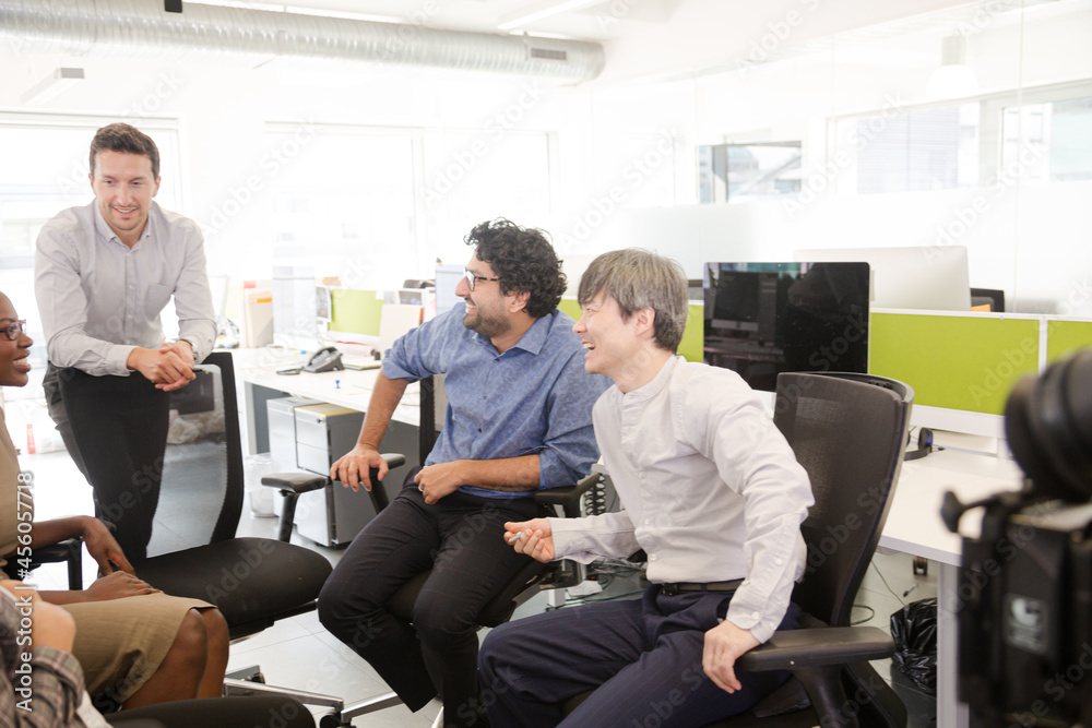 Business people meeting at computer in open plan office