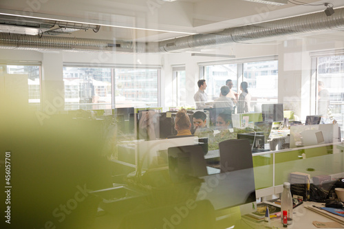 Business people talking in open plan office © KOTO