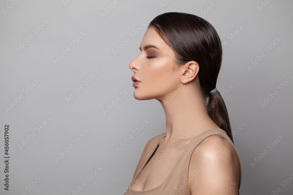 Woman profile. Attractive female model with healthy skin and dark hair. Skincare, cosmetology and facial treatment concept