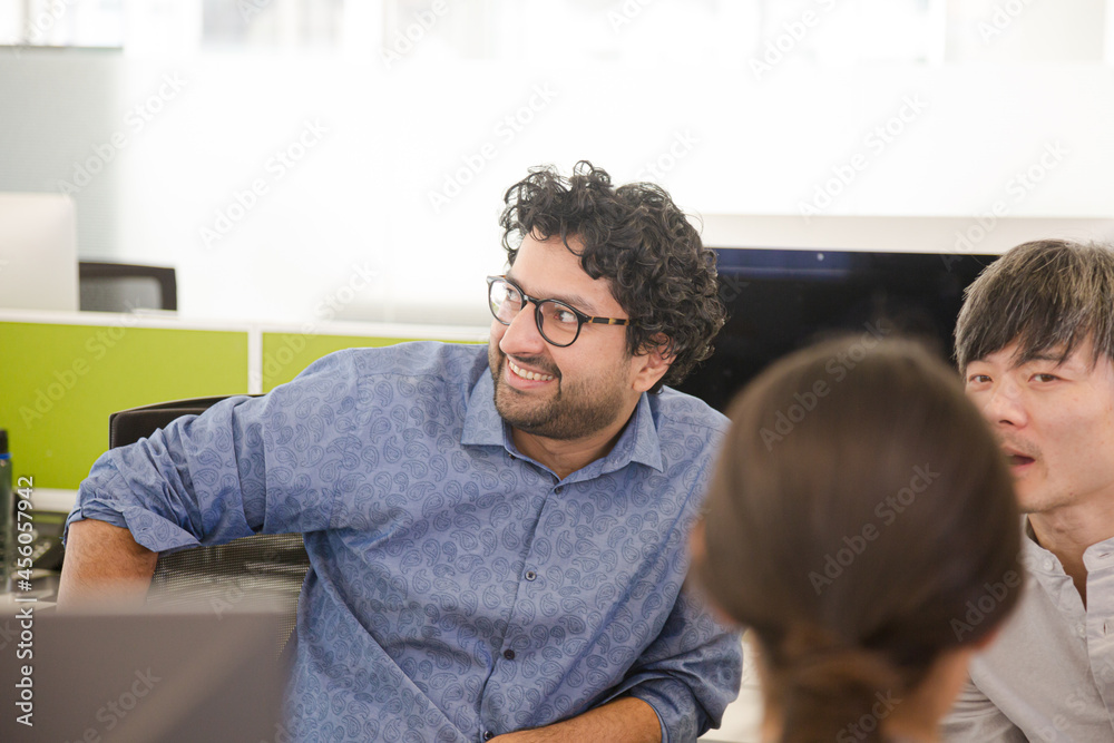 Business people meeting at computer in open plan office Business people meeting at computer in open plan office