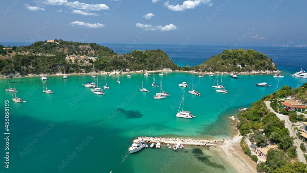 Fototapeta premium Aerial drone photo of iconic port and fishing village of Lakka or Laka with traditional Ionian architecture a safe anchorage for sail boats and yachts, Paxos island, Ionian, Greece