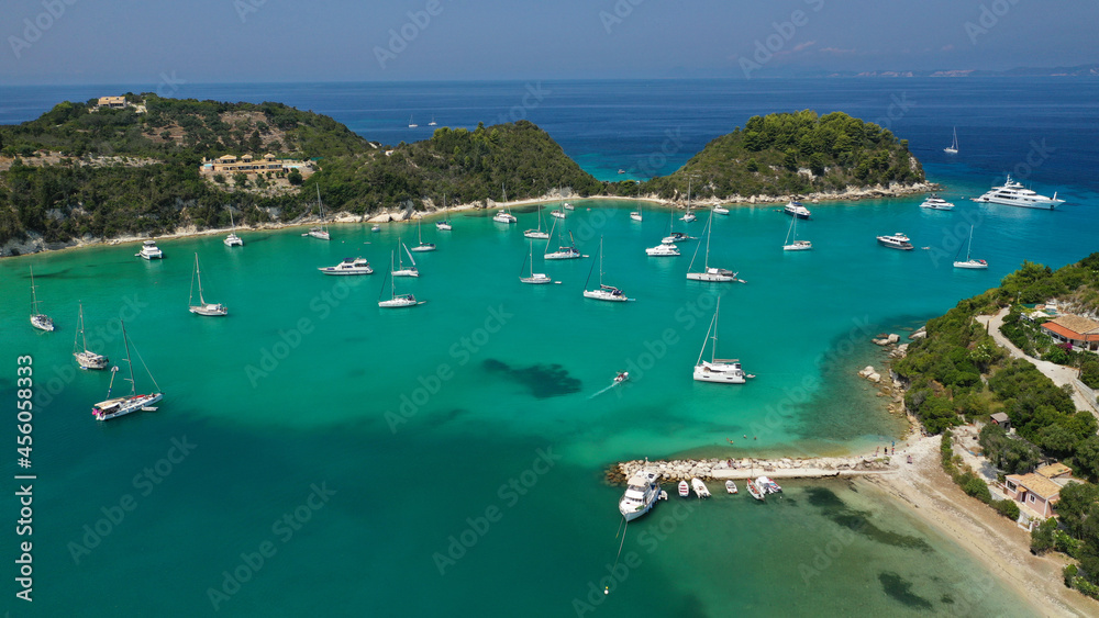 Obraz premium Aerial drone photo of iconic port and fishing village of Lakka or Laka with traditional Ionian architecture a safe anchorage for sail boats and yachts, Paxos island, Ionian, Greece