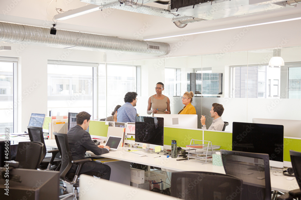 Business people meeting in open plan office Business people meeting in open plan office