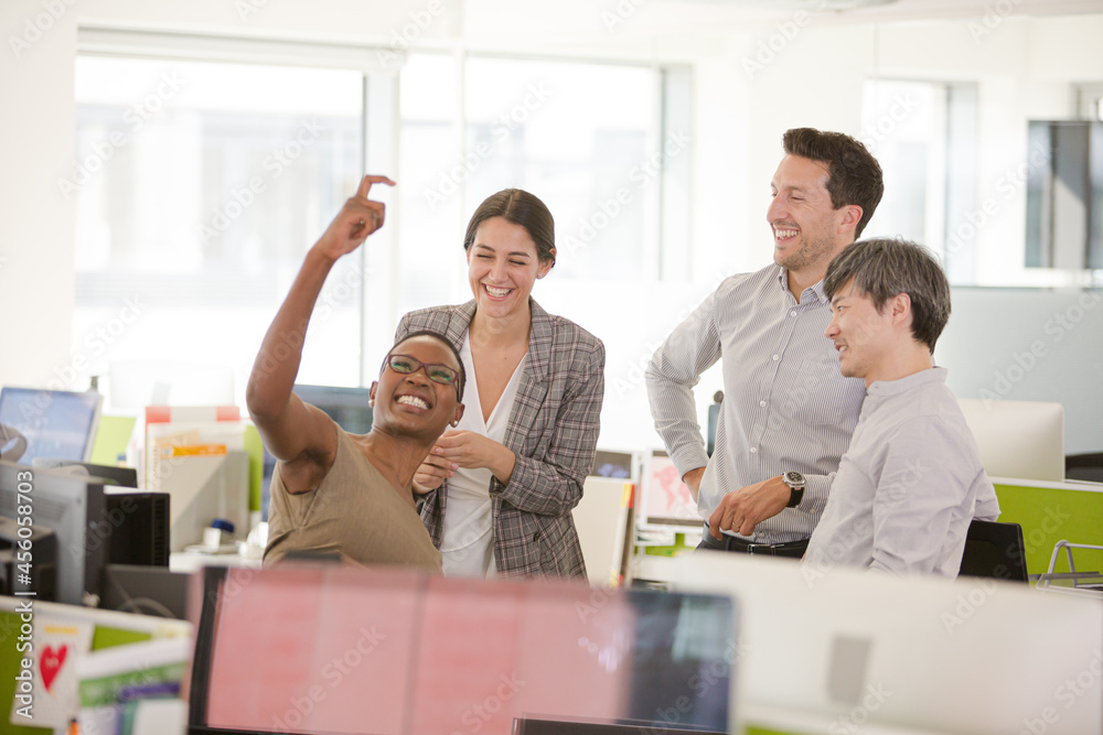 Business people talking in open plan office Business people talking in open plan office