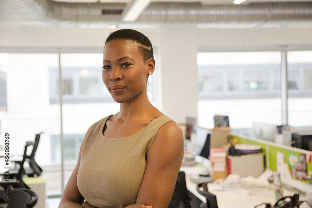 Portrait of smiling, confident businesswoman in open plan office Portrait of smiling, confident businesswoman in open plan office