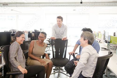 Business people meeting at computer in open plan office