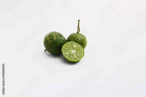 Lime or Limau (Citrus amblycarpa) isolated on white background. Used for spice in cooking, Lime or Limau (Citrus amblycarpa) is one of the native Citrus species of West Java, Indonesia. photo