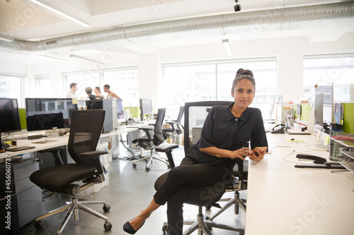 Portrait of businesswoman in open plan office