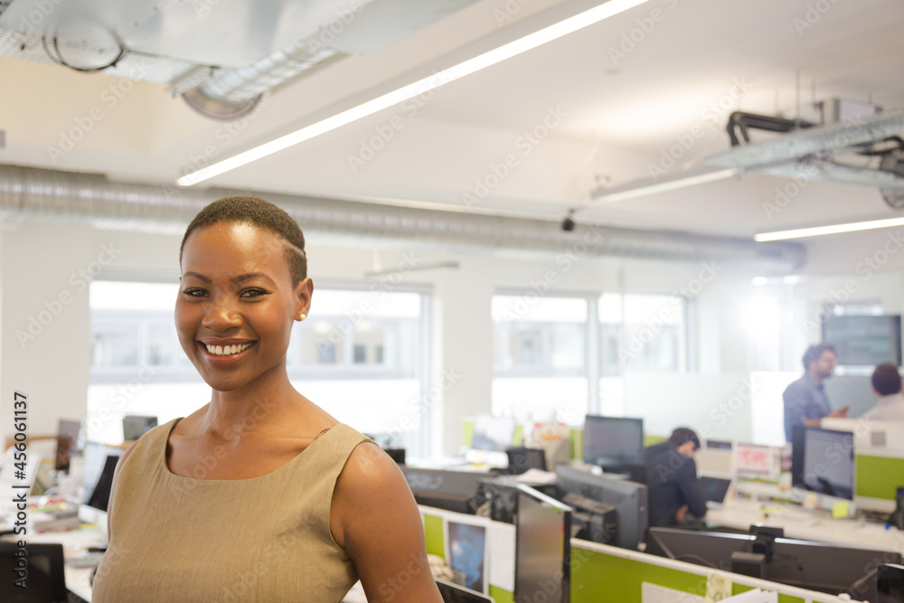 Portrait of smiling, confident businesswoman in open plan office Portrait of smiling, confident businesswoman in open plan office