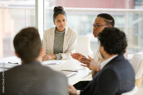 Businesswoman leading conference room meeting