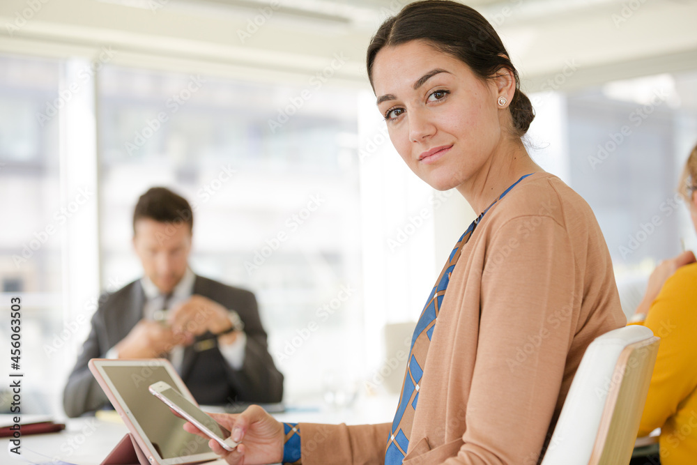 Portrait of smiling businesswoman in conference room meeting