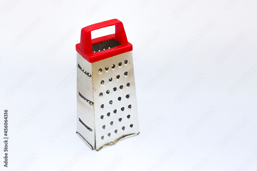 Grater with red handle isolated on white background. Kitchen utensil background stock images. Grater with red handle isolated on white background. Kitchen utensil background stock images.
