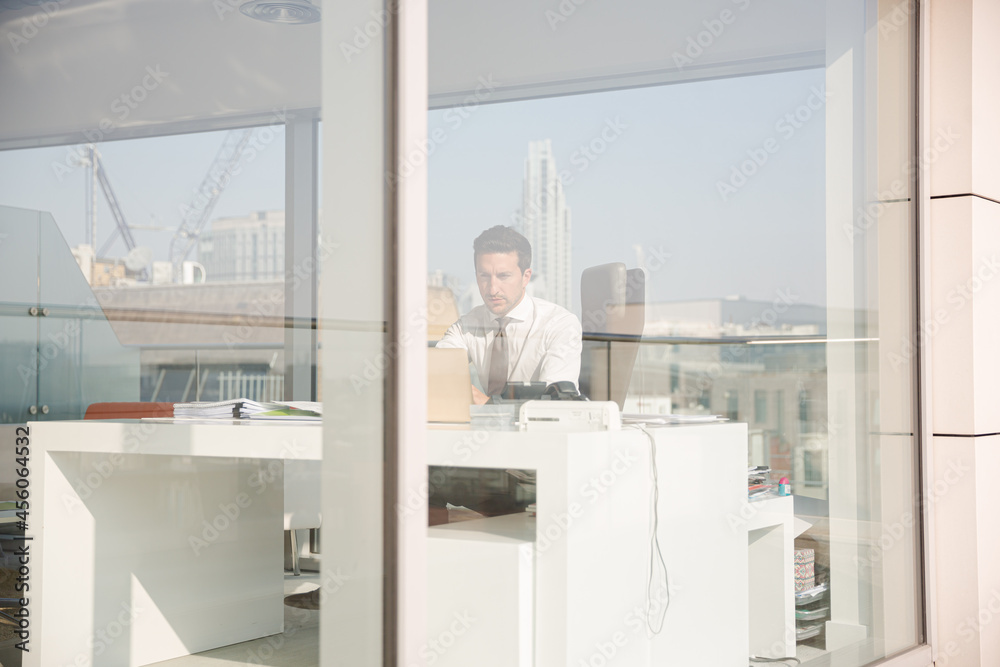Businessman working at desk in modern office