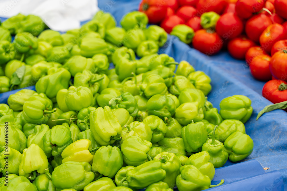 Green bell peppers and tomatoes on vegetable market. Green bell peppers and tomatoes on vegetable market.