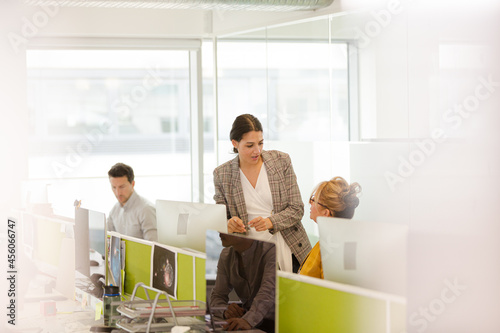 Business people brainstorming in open plan office