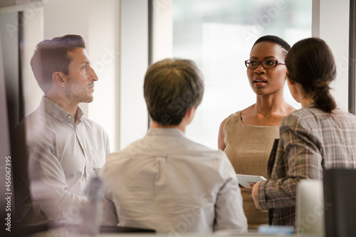 Business people talking in open plan office