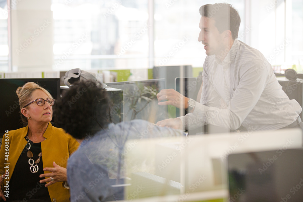 Business people brainstorming in open plan office Business people brainstorming in open plan office