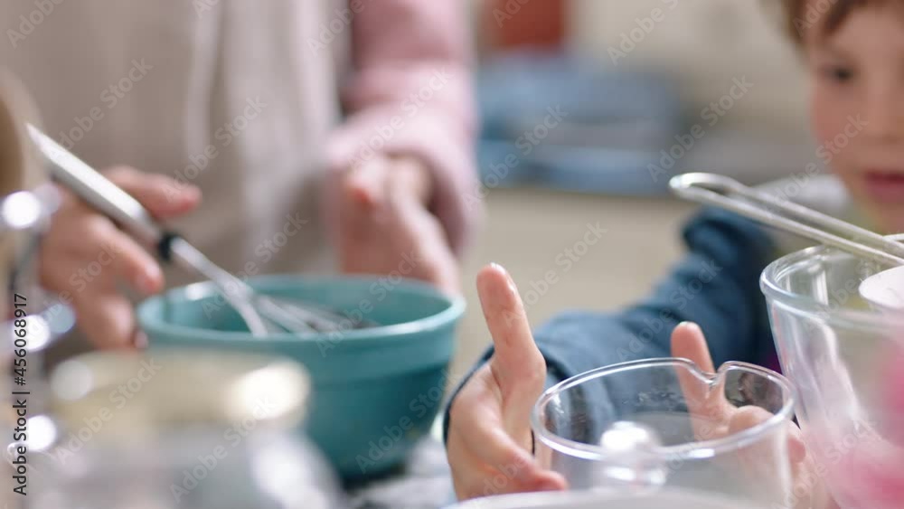 happy little boy helping mother bake in kitchen mixing ingredients baking chocolate cupcakes preparing recipe at home happy little boy helping mother bake in kitchen mixing ingredients baking chocolate cupcakes preparing recipe at home