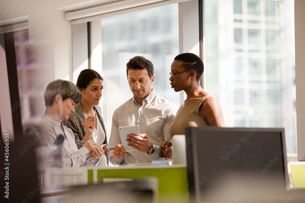 Business people talking in open plan office Business people talking in open plan office
