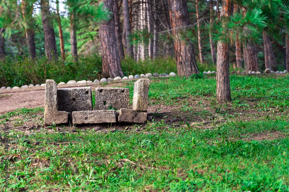 A bench of concrete blocks of different sizes stands on the ground A bench of concrete blocks of different sizes stands on the ground
