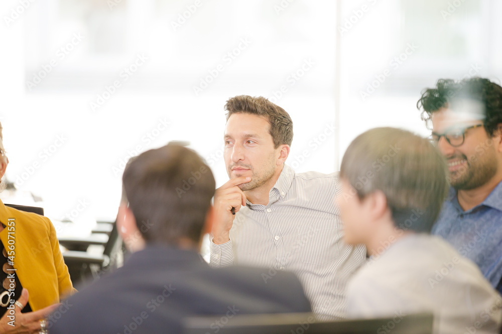 Business people brainstorming in open plan office Business people brainstorming in open plan office