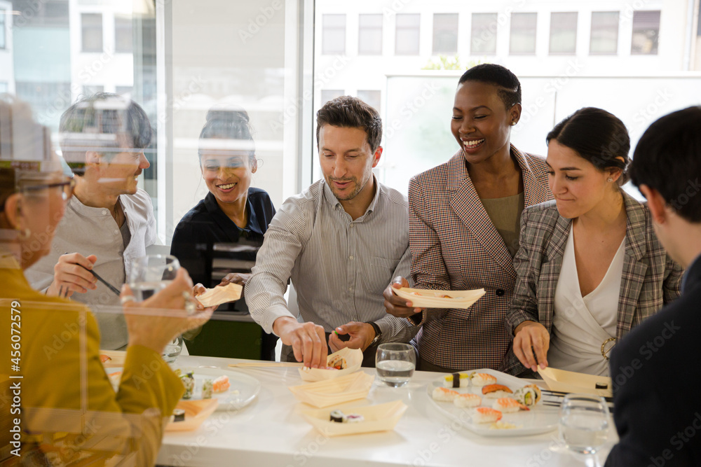 Business people enjoying sushi lunch Business people enjoying sushi lunch