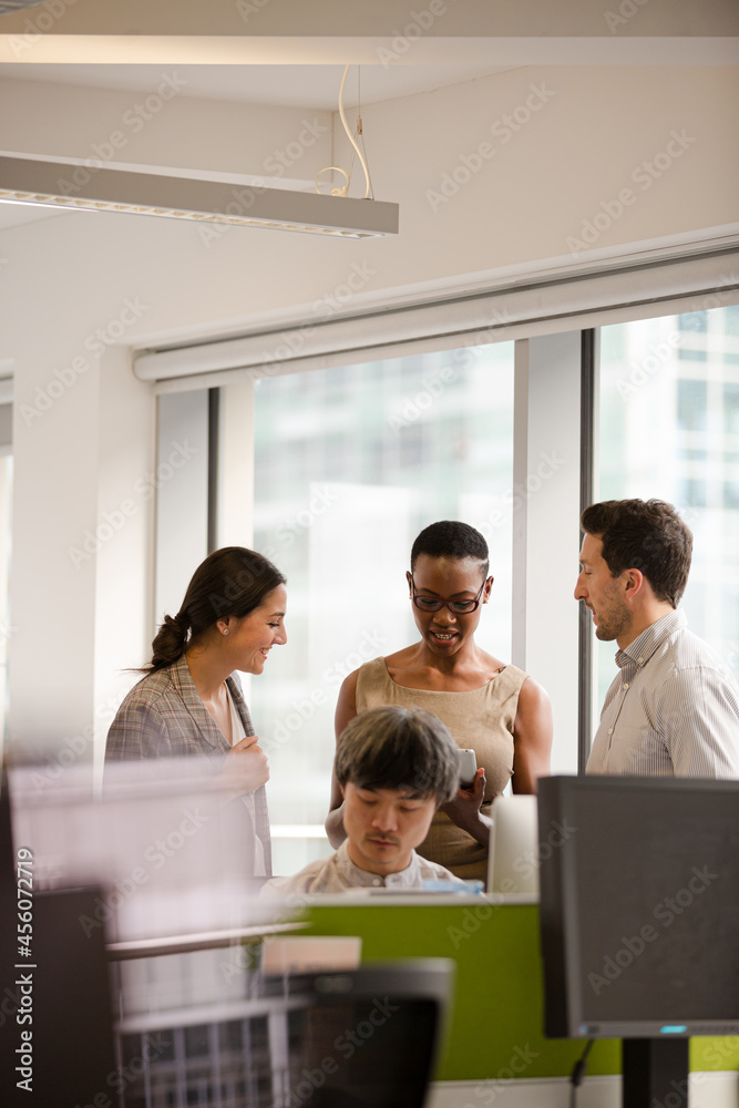 Business people talking in open plan office Business people talking in open plan office