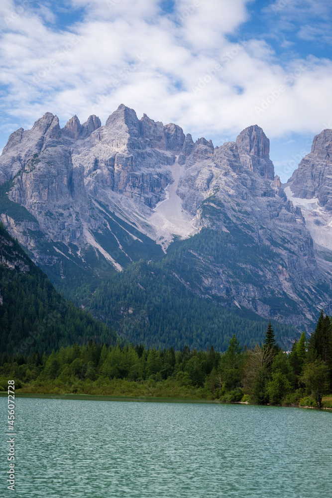 A majestic view of Durrensee lake in Italy surrounded by beautiful forested mountains in the Dolomites at summer in south Tirol