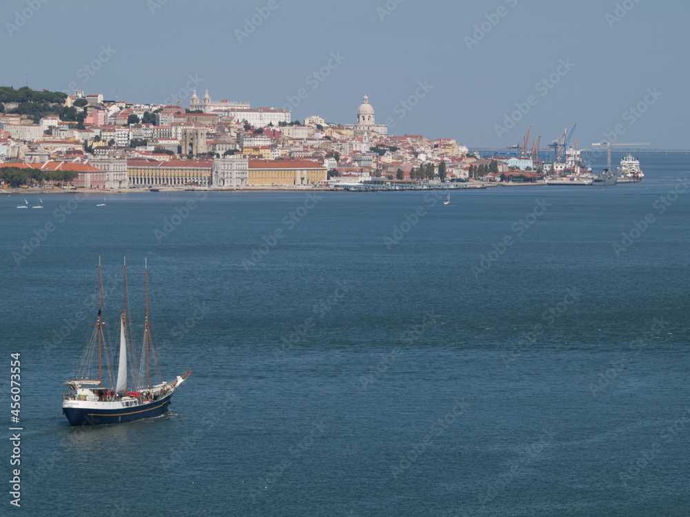 Sailboat in river Tagus in Lisbon with downtown in background