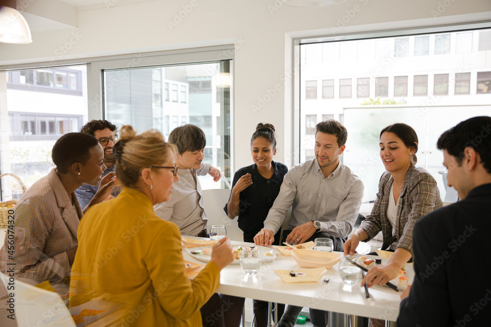 Business people enjoying sushi lunch Business people enjoying sushi lunch