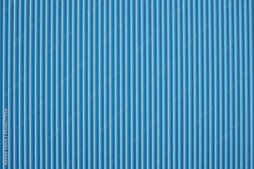 Closeup of blue striped perforated paper background