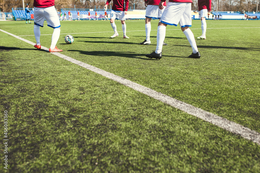 Football team players warm up before the match do exercise with the ball