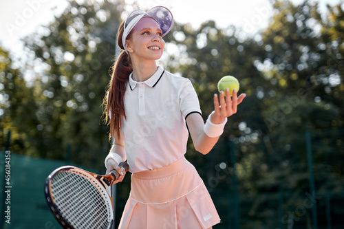Young Positive Caucasian Tennis Player On Hardcourt During Game At Summer Day, Fit And Slim Adult Lady In Uniform Enjoy Sport Game,Preparing For Competition. Professional Athlete Portrait © Roman