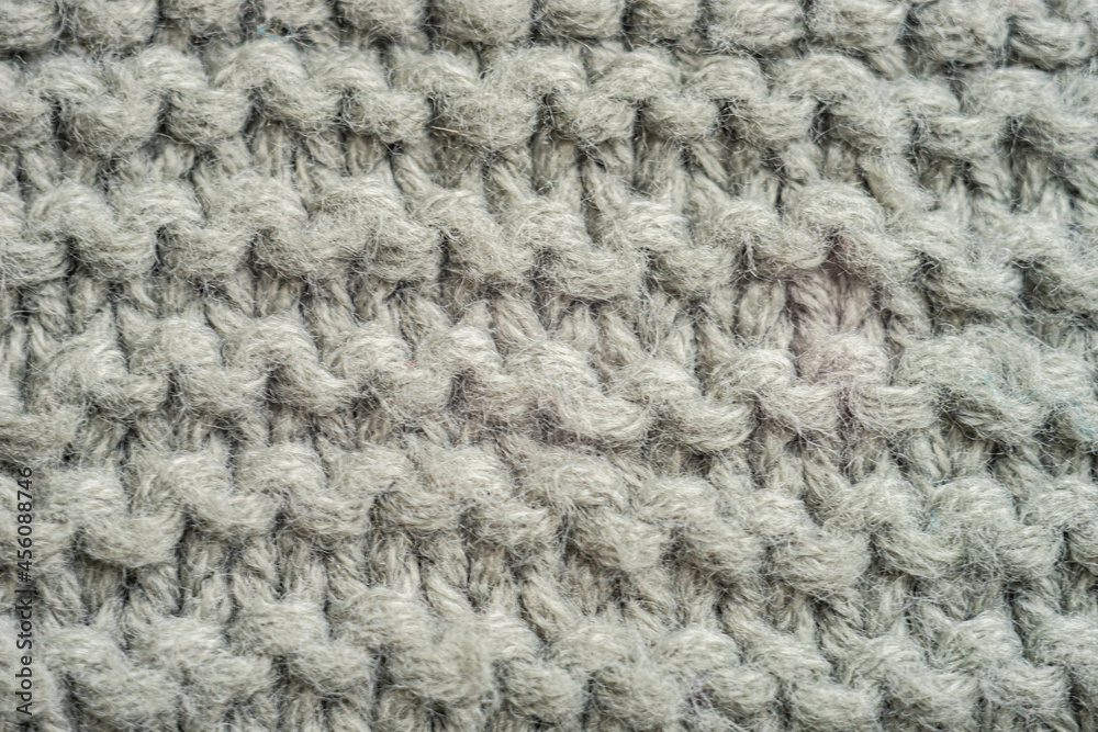 Pale grey background of knitted thread pattern Pale grey background of knitted thread pattern