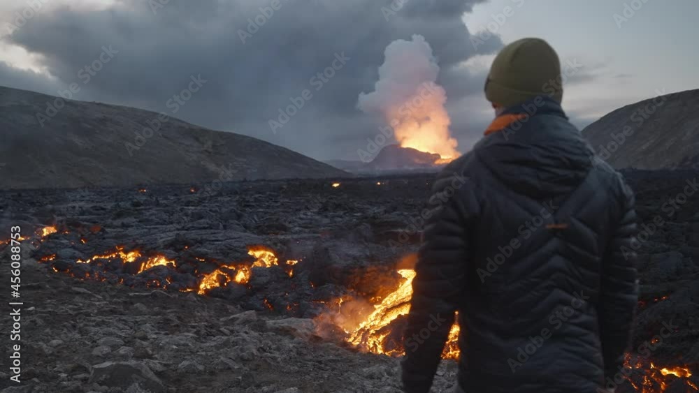 Man Watching Lava Flow From Erupting Fagradalsfjall Volcano Man Watching Lava Flow From Erupting Fagradalsfjall Volcano