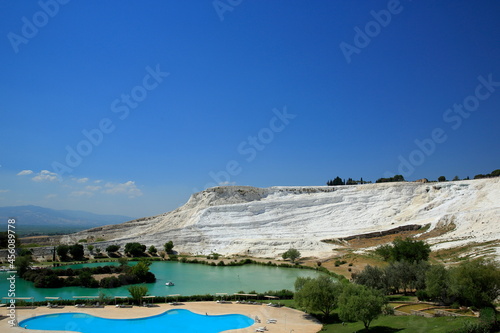 Pamukkale, Turkey. This region is a touristic city famous for its travertine formed by leaving white residue on the rock structure due to the water coming out of the rich carbonated water source.