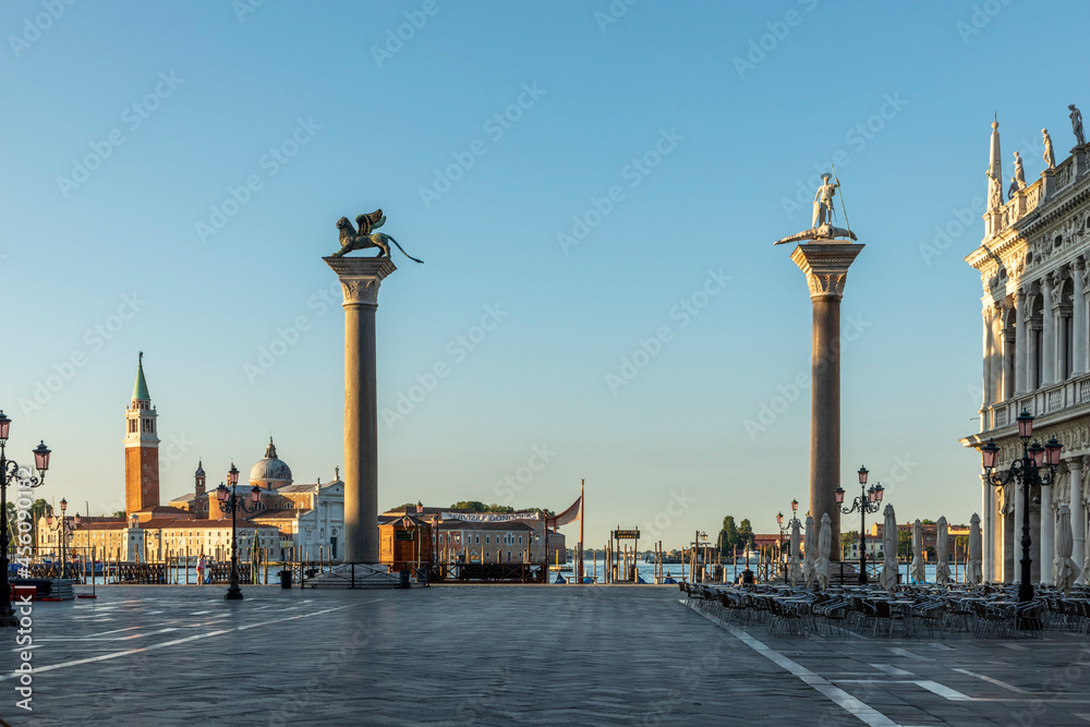 early morning view with rising sun to pillar with lion and dragon fighter at St. Mark's square in Venice