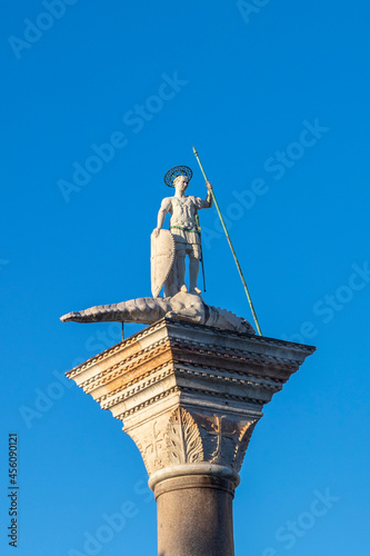 Sculpture of Sacred Teodor - the first patron of Venice standing on a dragon won by it. It is established at column top on Piazza San Marco, Venice photo