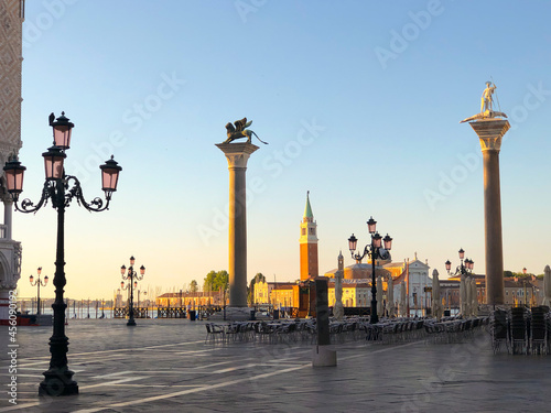 Sculpture of Sacred Teodor - the first patron of Venice standing on a dragon won by it and sculpture of the vebetian lion with wings on Piazza San Marco, Venice © travelview