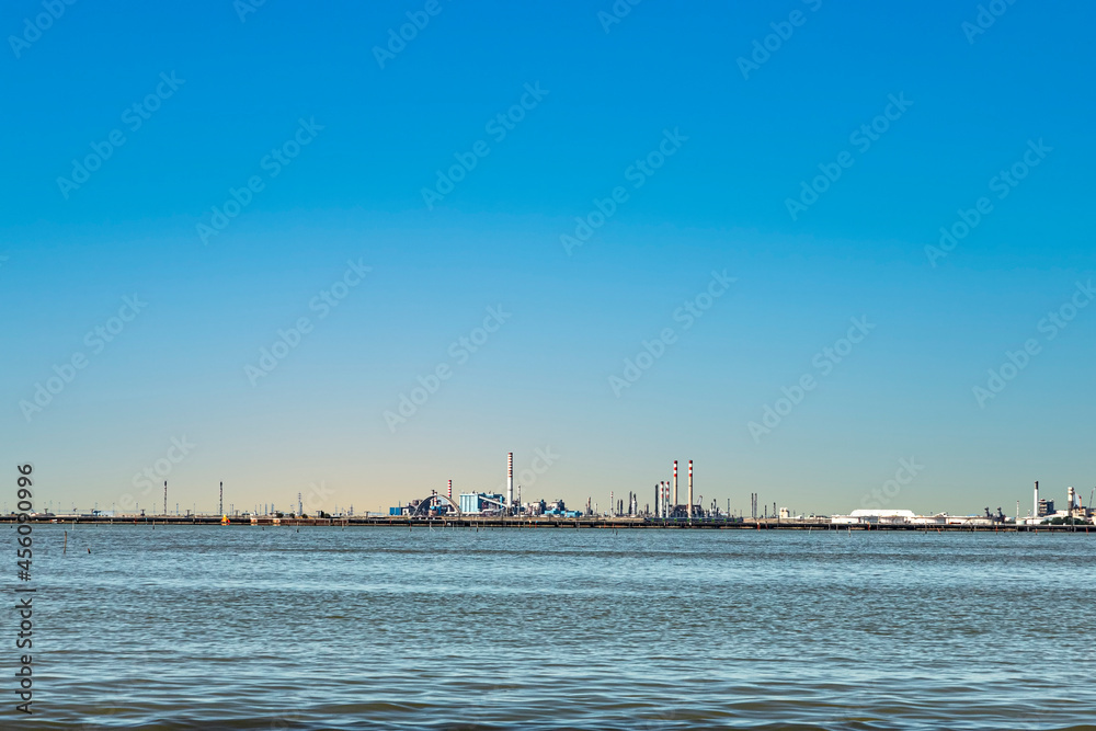 industry area at the horizon in lagoon of Venice seen from motorboat way to venice
