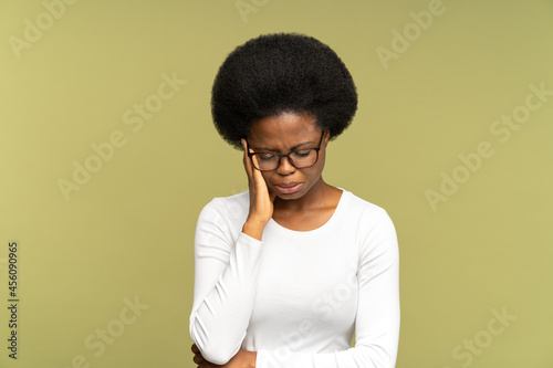 Unhappy African woman cry covering face with hands and embracing herself. Tired stressed girl disappointed and upset emotional feel bad after break up or dismissal at work, dissatisfied and depressed.