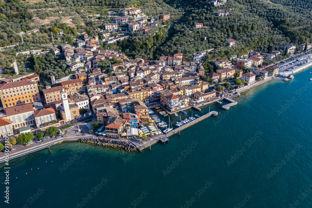Brenzone sul Garda, Italy, September 2021, aerial view of Castelletto di Brenzone at Garda (Lake),  showing the coastline with roads and the tranquil coastal villages with a small harbor (port)