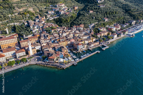 Brenzone sul Garda, Italy, September 2021, aerial view of Castelletto di Brenzone at Garda (Lake),  showing the coastline with roads and the tranquil coastal villages with a small harbor (port) © Mario Hagen