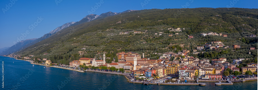 Brenzone sul Garda, Italy, September 2021, aerial panoramic view of Castelletto di Brenzone at Garda (Lake),  showing the coastline with roads and the tranquil coastal villages with a small port