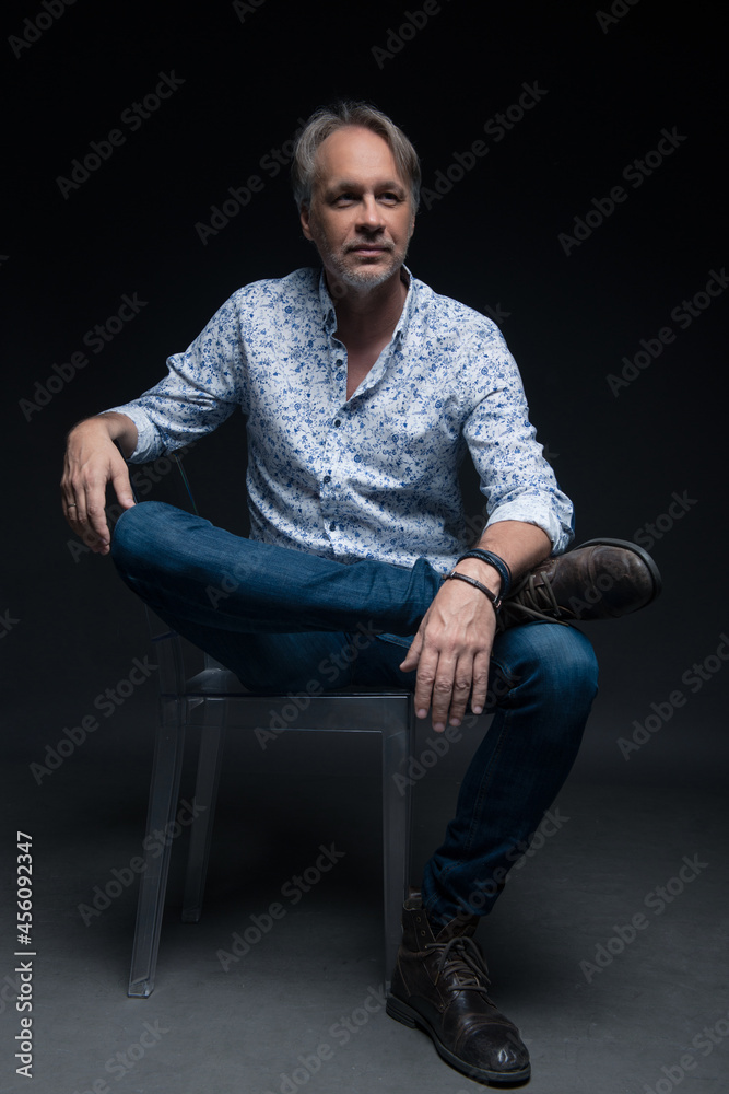 Attractive mature man with beard on plain background wearing casual Attractive mature man with beard on plain background wearing casual