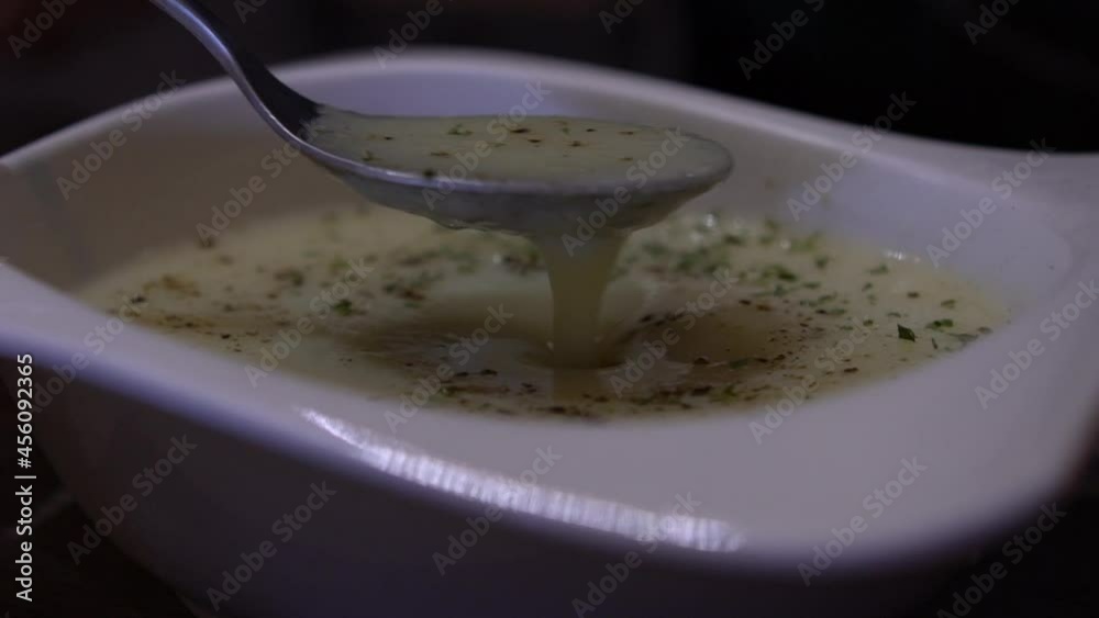 Slow motion of dish of delicious soup on the table of the restaurant. Appetizer typical taiwanese recipe of courn soup served on a white bowl. Traditional cuisine of Taiwan.-Dan Slow motion of dish of delicious soup on the table of the restaurant. Appetizer typical taiwanese recipe of courn soup served on a white bowl. Traditional cuisine of Taiwan.-Dan