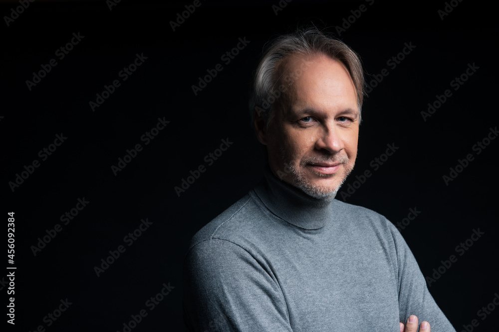 Attractive mature man with beard on plain background wearing casual Attractive mature man with beard on plain background wearing casual